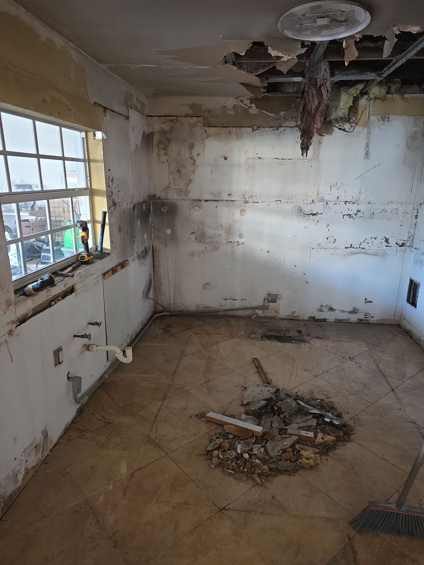 Empty room after fire damage cleanup with collapsed ceiling